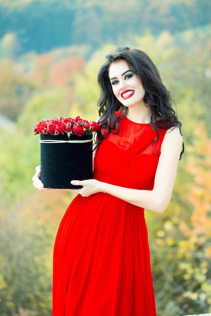 Sexy smiling girl with red roses