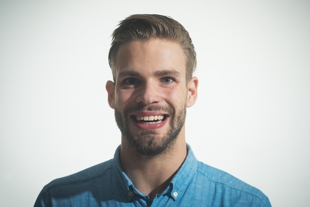 Sexy smiling handsome unshaven man in denim shirt positive emotions feelings facial expressions