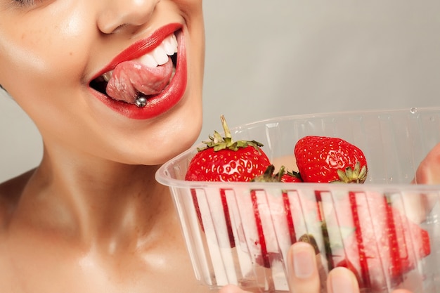 Sexy Woman Eating Strawberry. Sensual Lips.