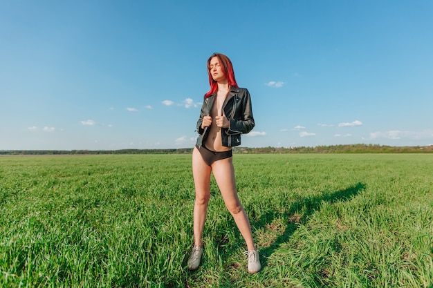 Sexy woman in a leather black jacket and black panties