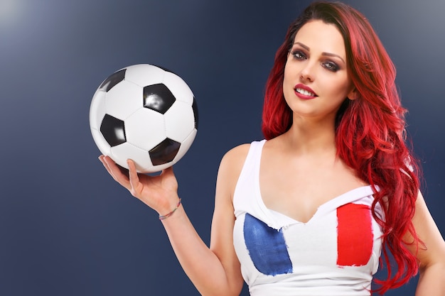 sexy woman wearing french flag and holding football