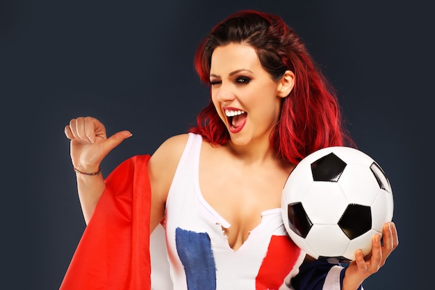 sexy woman wearing french flag and holding football