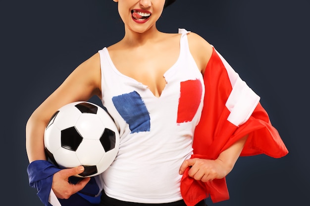 sexy woman wearing french flag and holding football