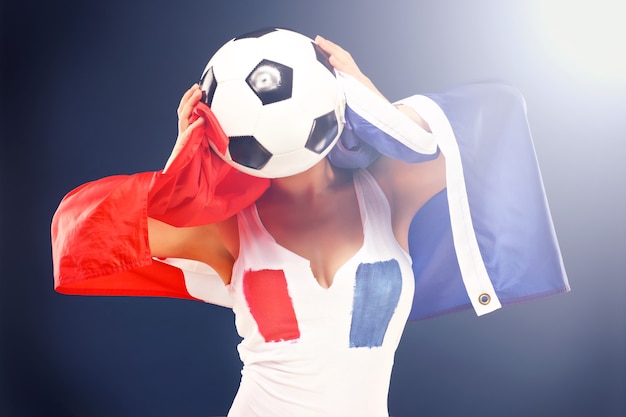 sexy woman wearing french flag and holding football