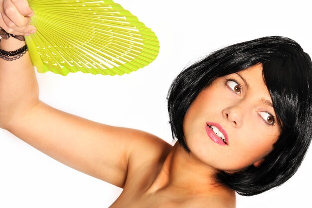 a sexy woman with a green fan over white