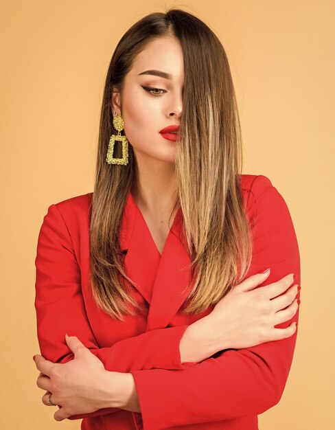 Sexy woman with professional makeup jewelry earrings girl in\
red jacket beauty and fashion hair beauty and hairdresser salon\
fashion portrait of elegant woman funky beauty