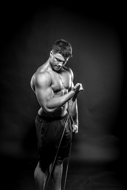 Sexy young athlete posing. Fitness, bodybuilding, black and white