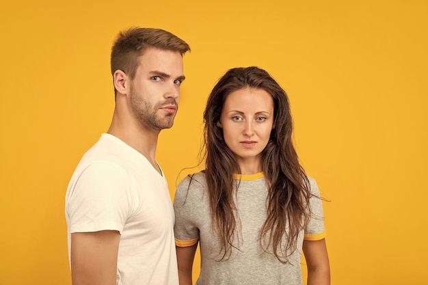 Sexy young couple in love on yellow background love