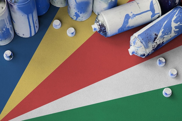 Seychelles flag and few used aerosol spray cans for graffiti painting Street art culture concept