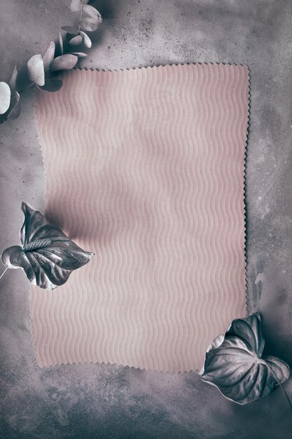 Photo shabby chic monochrome background with eucalyptus dry cala lily flowers painted metallic pink copyspace place for text on paper low contrast moody autumntime simple minimal frame