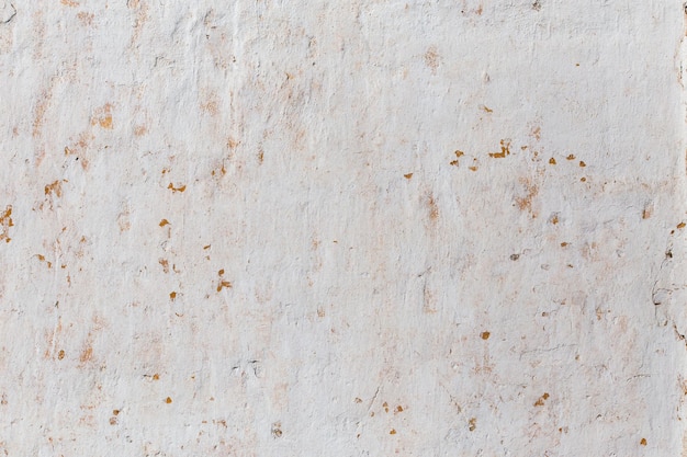 Shabby flat plaster wall with yellow streaks