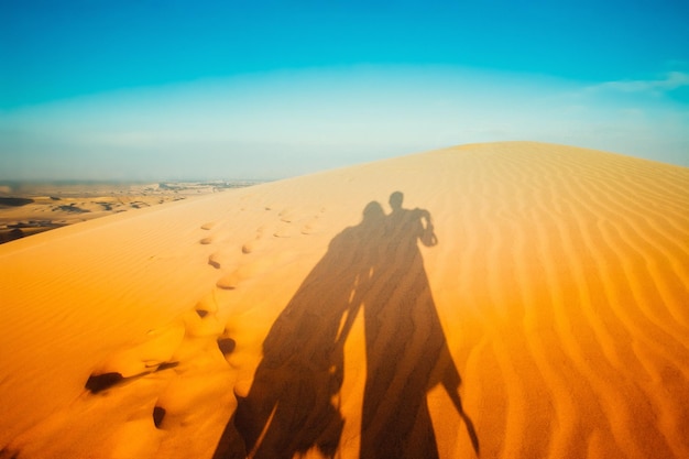 Shadow of a couple in love in the desert