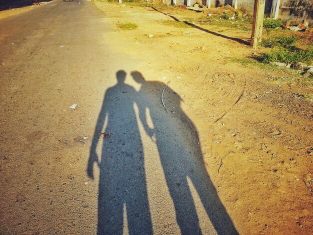 Photo shadow of friends on road