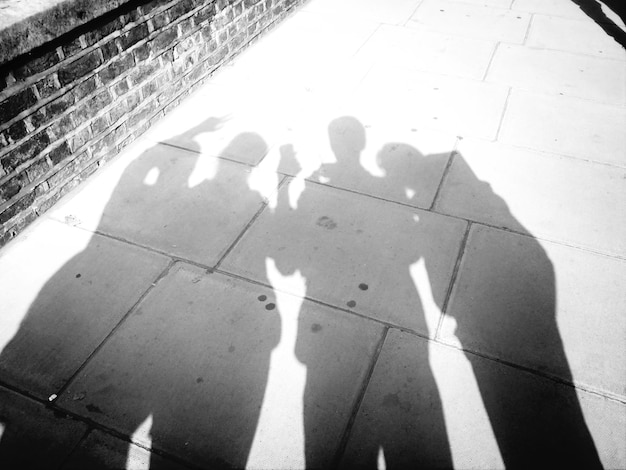 Photo shadow of friends on sidewalk