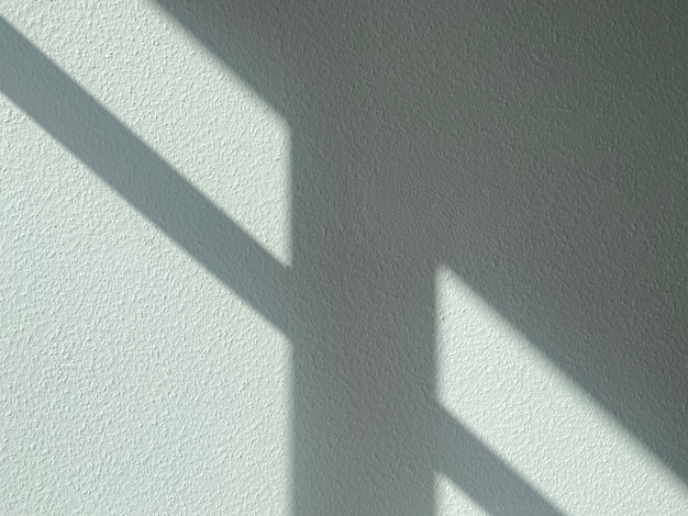 Shadow from the sun on a gray rough wall. Abstract texture