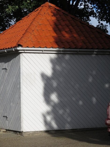 Shadow of house on wall by building