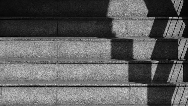 The shadow of the iron railing on the concrete stairs