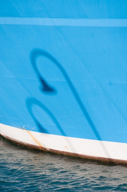 Shadow of a lamppost on the side of a ship