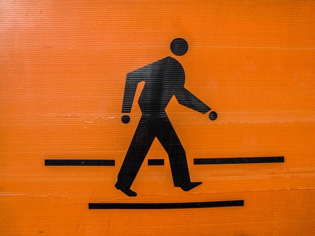 Shadow of man on orange wall