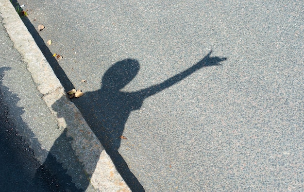 Shadow of man on road