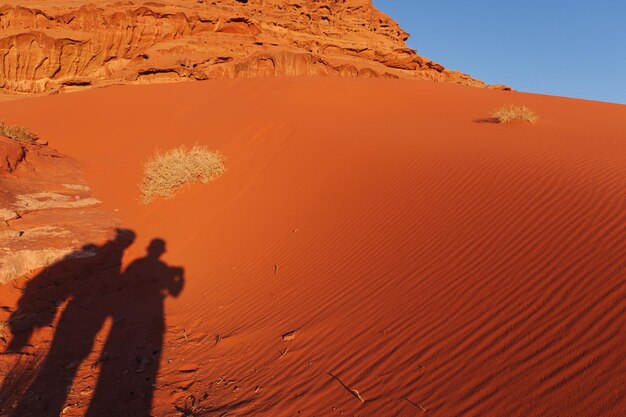 Shadow of man on sand dune