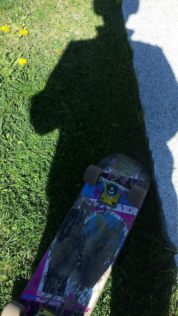 Shadow of man on skateboard and field