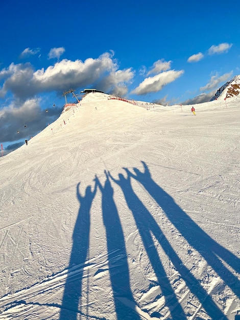 Shadow of people on snow covered land