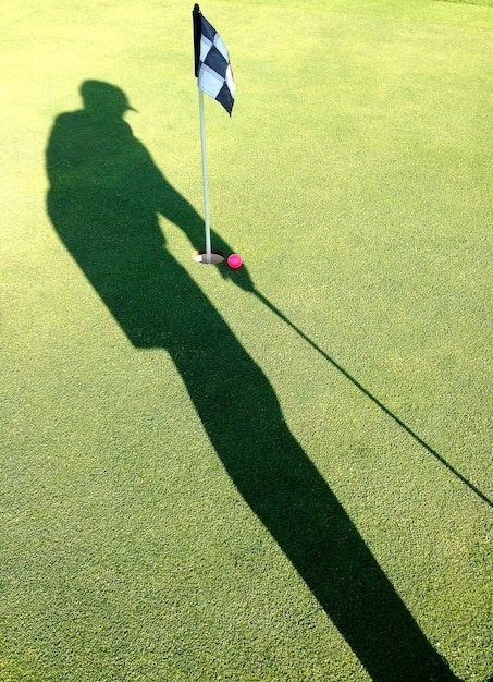 Shadow of person on golf court