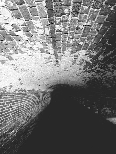 Photo shadow of person on illuminated walkway