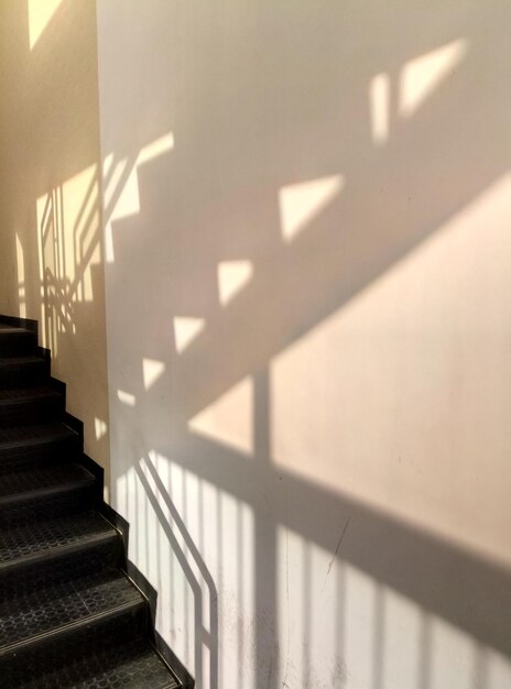 Photo shadow of staircase on wall