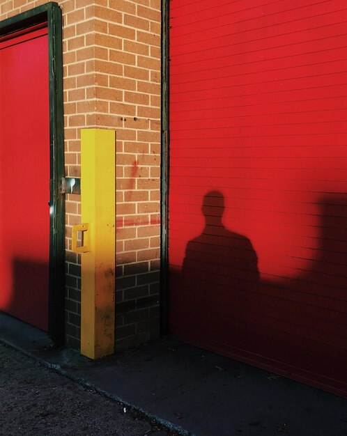 Shadow of window on red door