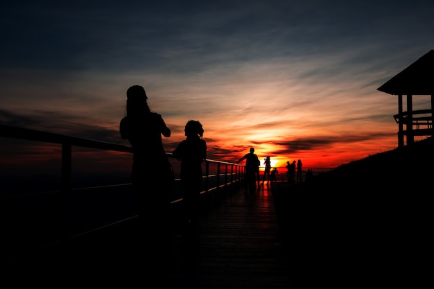 Shadow of women at the top of the mountain During sunset