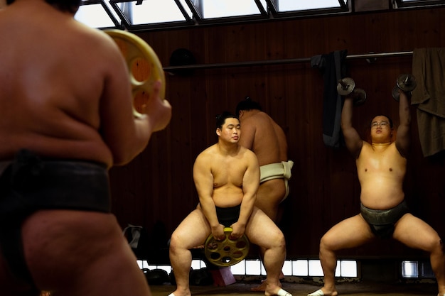 Shadows of Strength Sumo Wrestlers Face Off in Low Key Training