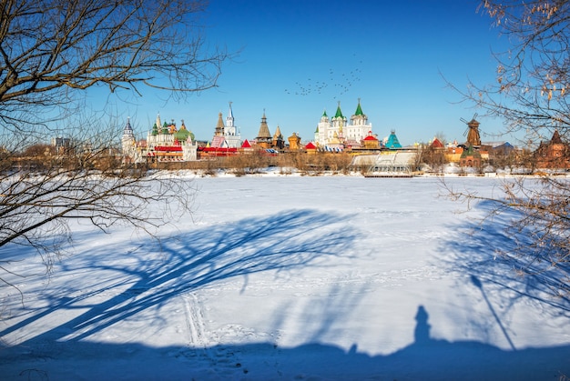 The shadows of the trees in the snow near the Izmailovo Kremlin in Moscow