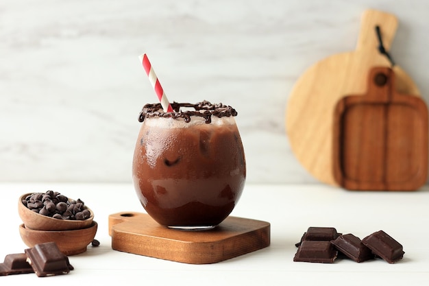 Shake Iced Chocolate with Creamy Choco Sauce Served on Clear Glass on White Table Copy Space for Text