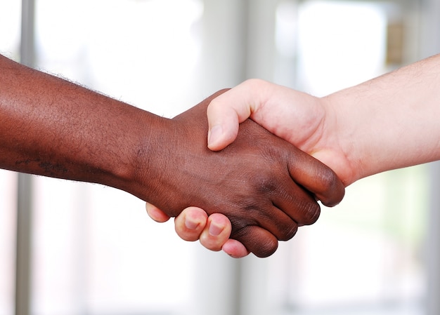 Shaking hands, black and white in the office