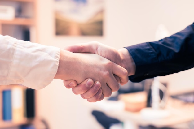 Shaking hands concept for teamwork Close up of man and woman shaking hands in the office