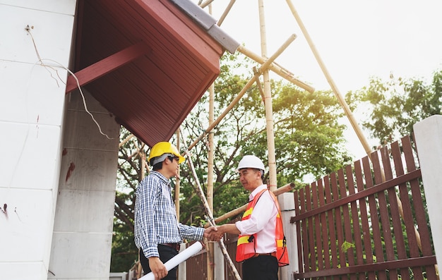 Shaking hands of foreman engineer teamwork deal house builder