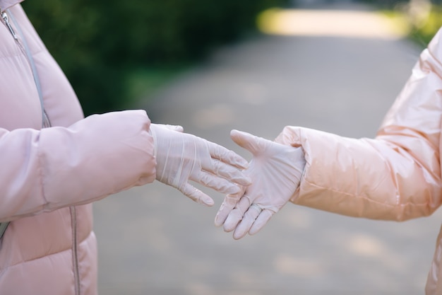 Shaking hands in medical gloves. Healthcare concept