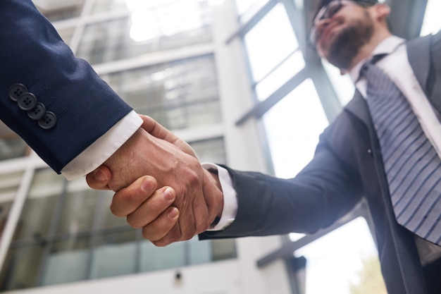shaking hands with business partner