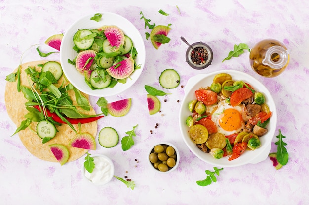 shakshuka and fresh salad cucumber, watermelon radish and arugula