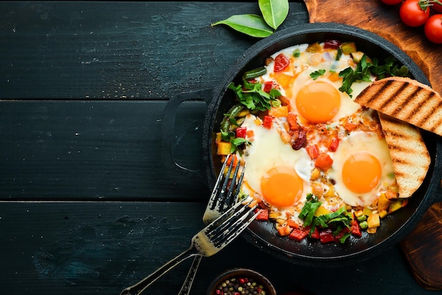 Shakshuka Fried eggs with vegetables in a frying pan Top view Traditional cuisine of Israel