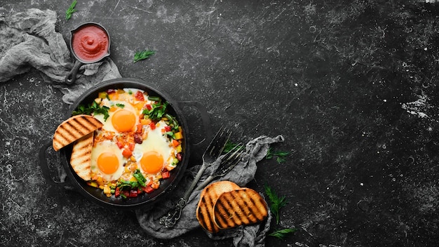 Shakshuka Fried eggs with vegetables in a frying pan Top view Traditional cuisine of Israel