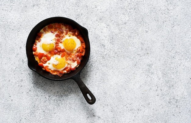 Shakshuka in a frying pan on the kitchen table