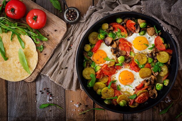 shakshuka in a frying pan on a wooden table in rustic style