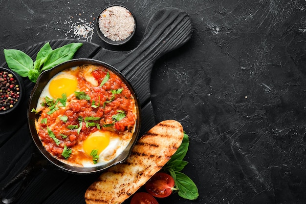 Shakshuka Scrambled eggs with tomatoes and vegetables Breakfast In the plate Top view Flat lay composition Free copy space