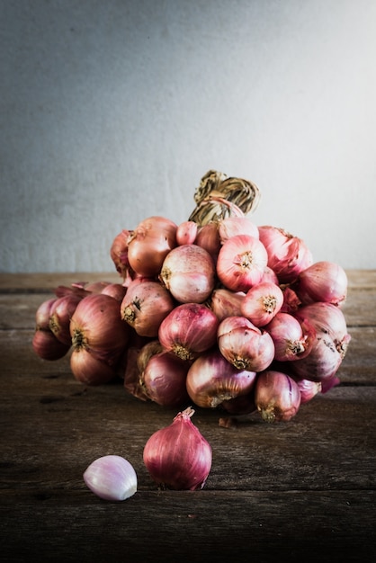 Shallot onions in a group on wooden table