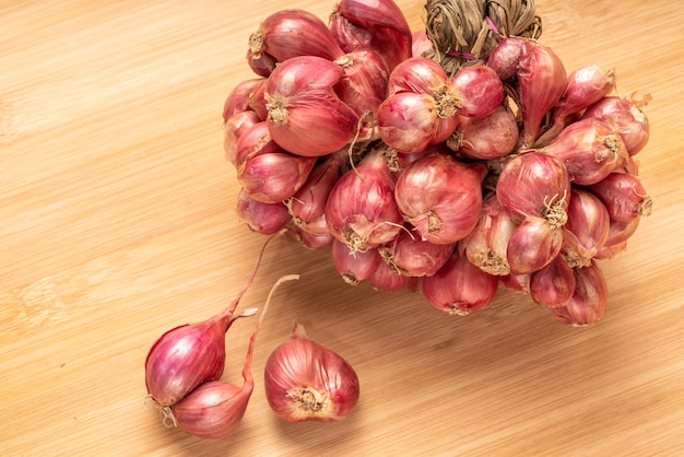 Shallots or Red Onion Asian herbs and cooking ingredients on wooden background