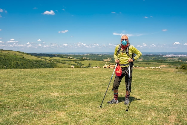 Shallow focus shot of an aged male traveler in a big field