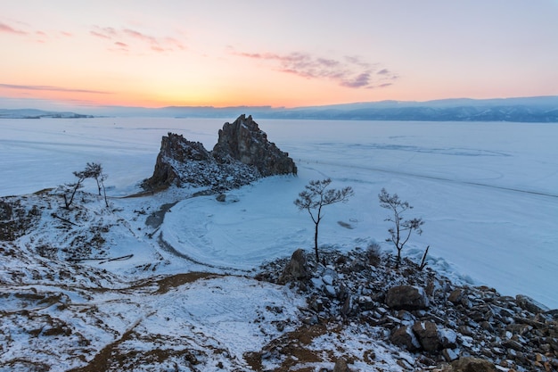 Shamanka rock in winter at sunset. Olkhon island, Baikal lake, Siberia, Russia.